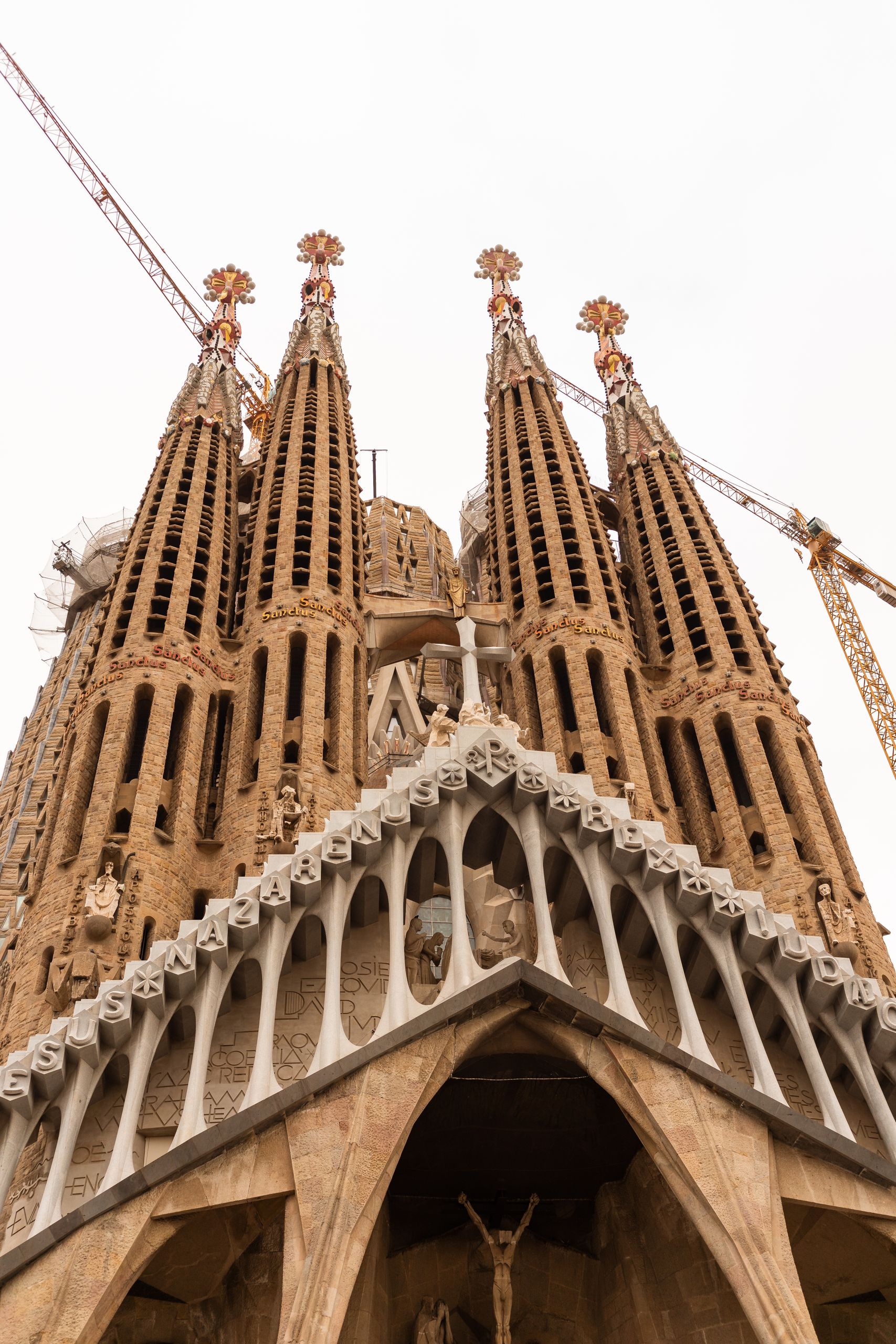 From below exterior of famous historic gothic basilica with ornamental details and spires located on street in Barcelona in Spain