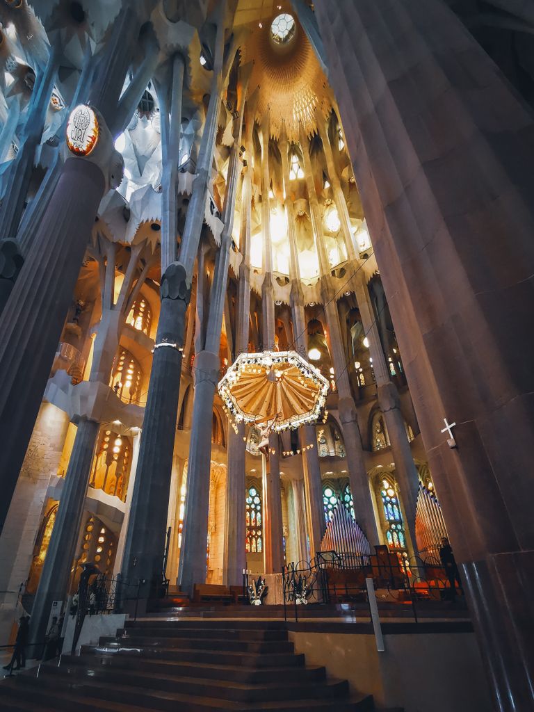 Stunning low angle shot of the illuminated interior of Sagrada Familia, Barcelona.
