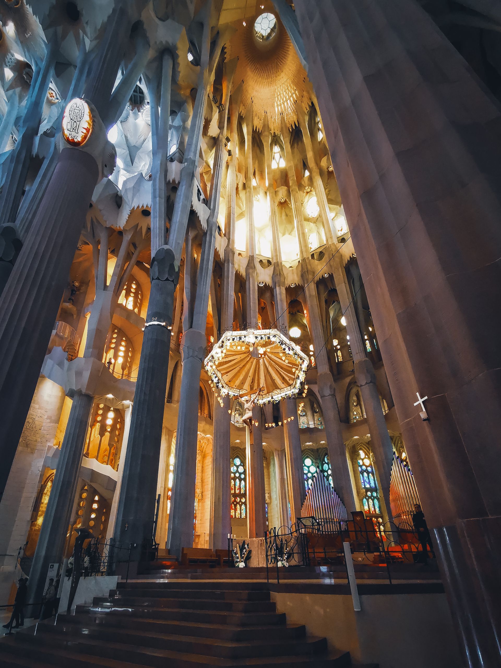 Stunning low angle shot of the illuminated interior of Sagrada Familia, Barcelona.