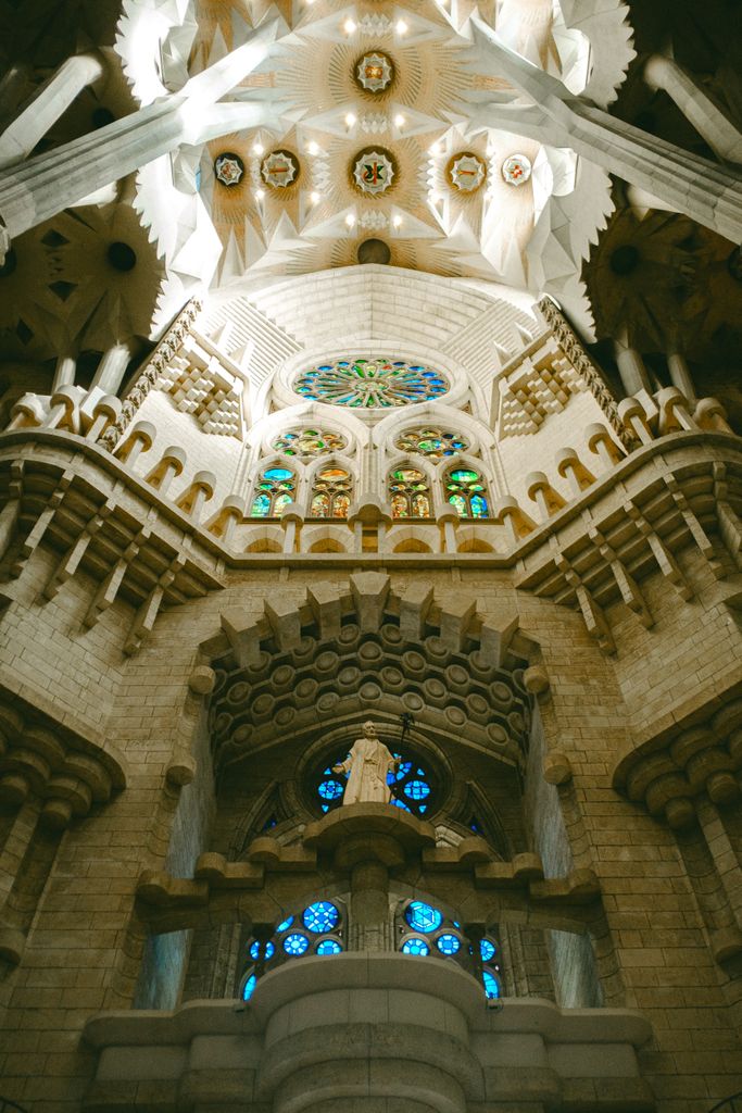 Stunning view of the intricately designed interior of a famous historic cathedral with colorful stained glass windows.